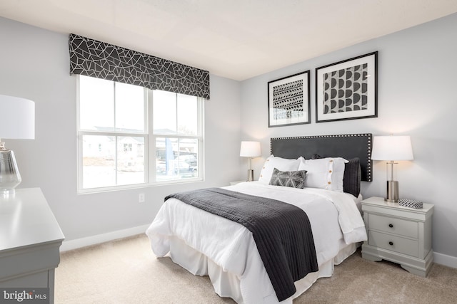 bedroom featuring baseboards and carpet flooring