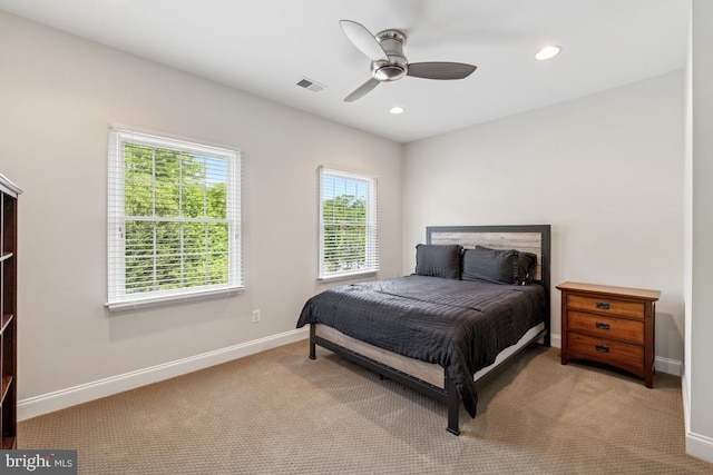 bedroom with carpet floors, multiple windows, and visible vents