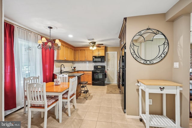 6 Swan Ln, Levittown, PA 19055 - kitchen featuring black appliances, decorative backsplash, light tile patterned flooring, a chandelier, and a sink
