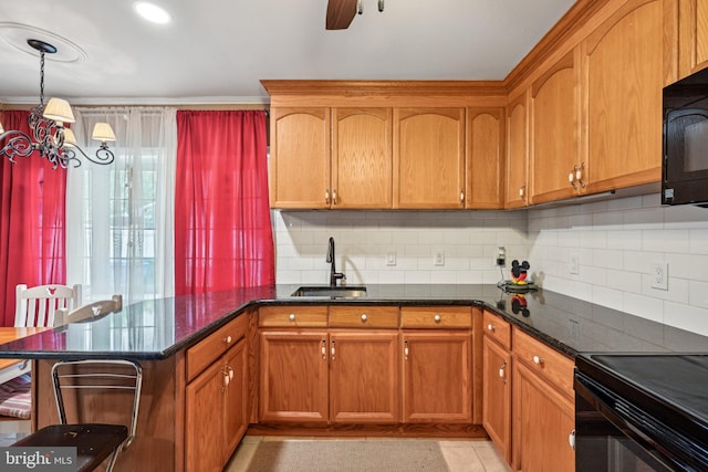 6 Swan Ln, Levittown, PA 19055 - kitchen with a sink, black appliances, decorative backsplash, and brown cabinetry