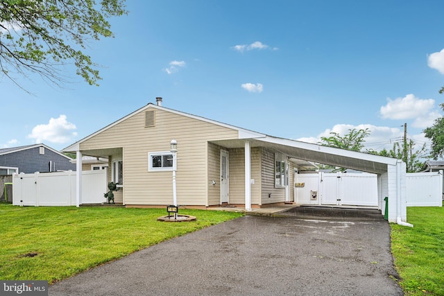 6 Swan Ln, Levittown, PA 19055 - view of front facade featuring asphalt driveway, a gate, and a carport