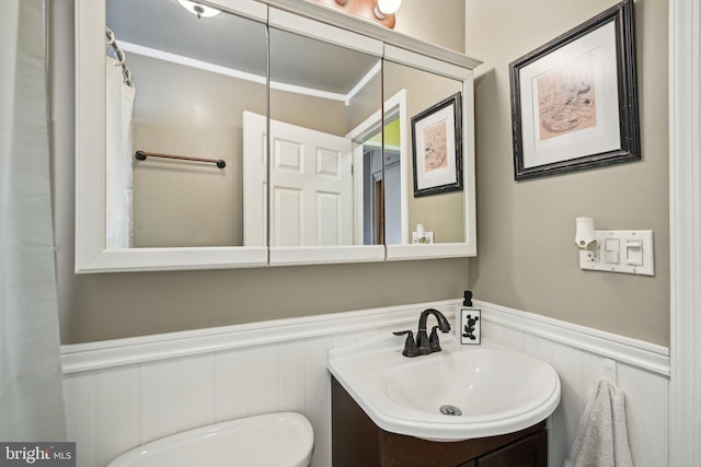 6 Swan Ln, Levittown, PA 19055 - bathroom with a wainscoted wall, a decorative wall, vanity, and toilet