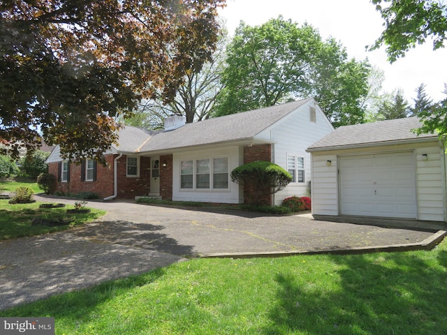 single story home featuring brick siding, driveway, a shingled roof, and a garage