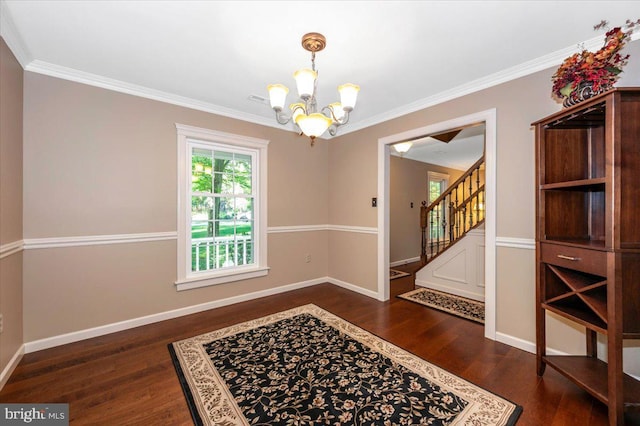unfurnished dining area featuring a notable chandelier, ornamental molding, dark wood finished floors, and stairway