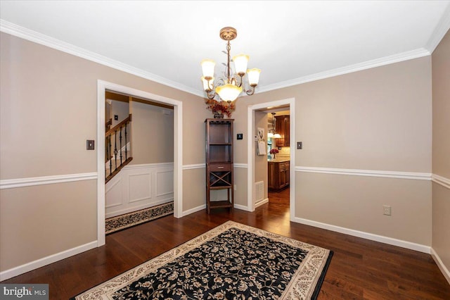 unfurnished dining area featuring wood finished floors, baseboards, a chandelier, ornamental molding, and stairs