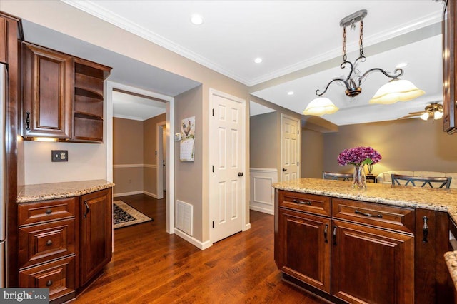 kitchen with visible vents, ornamental molding, light stone countertops, dark wood finished floors, and decorative light fixtures