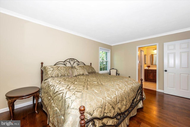 bedroom featuring baseboards, ornamental molding, ensuite bath, and hardwood / wood-style floors