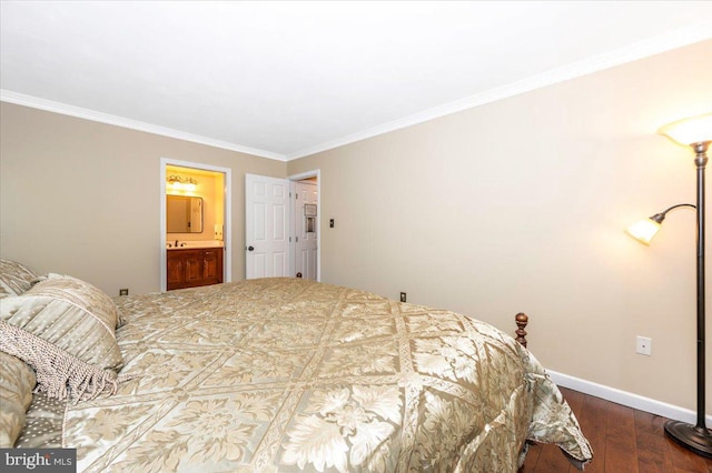 bedroom with connected bathroom, baseboards, dark wood-style floors, and ornamental molding