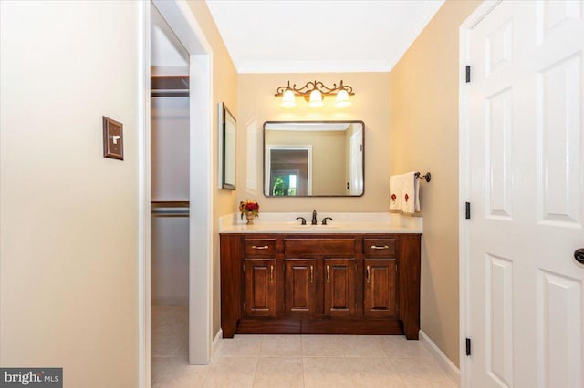 bathroom with baseboards, ornamental molding, tile patterned flooring, and vanity