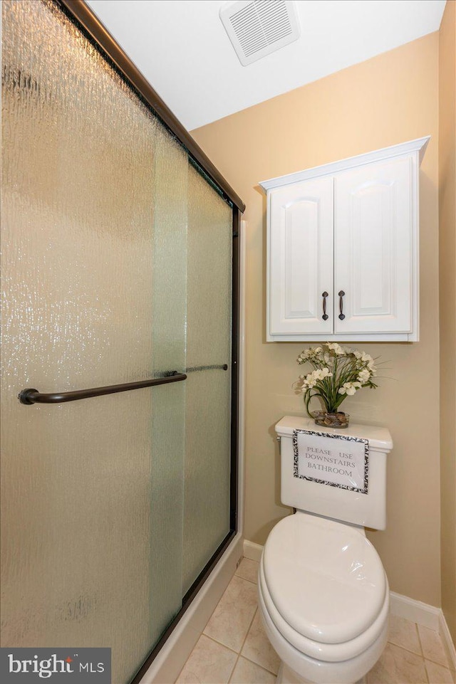 bathroom featuring tile patterned floors, baseboards, a stall shower, and visible vents