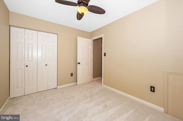 unfurnished bedroom featuring a closet, baseboards, a ceiling fan, and carpet flooring