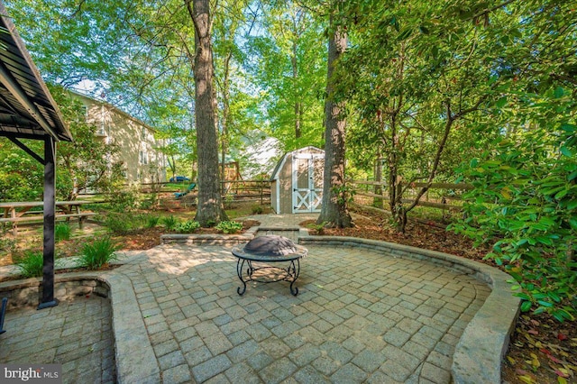 view of patio with an outbuilding, a shed, and a fenced backyard