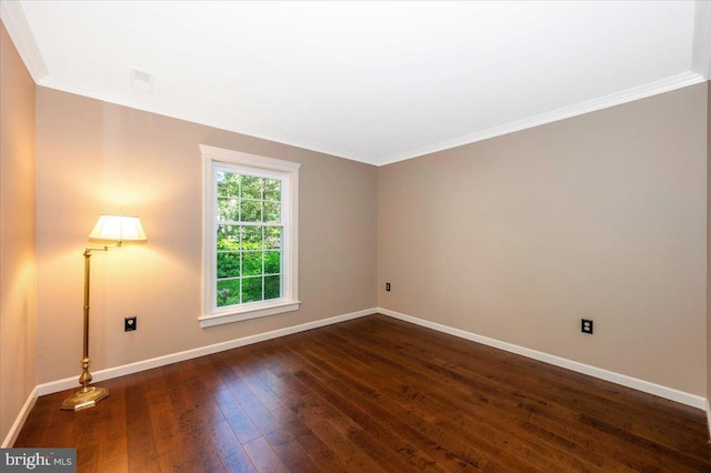 unfurnished room with crown molding, baseboards, dark wood-style flooring, and visible vents