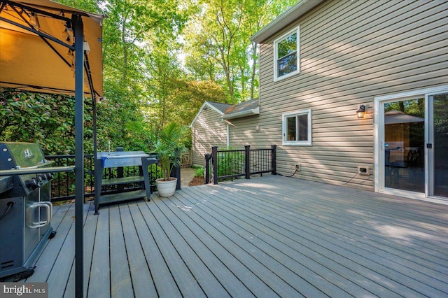 wooden deck with a grill