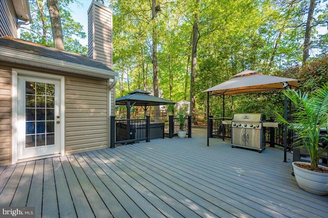 wooden deck with a gazebo and grilling area