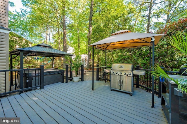 wooden deck with a gazebo and area for grilling