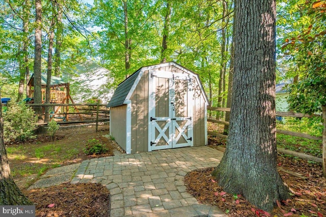 view of shed featuring fence