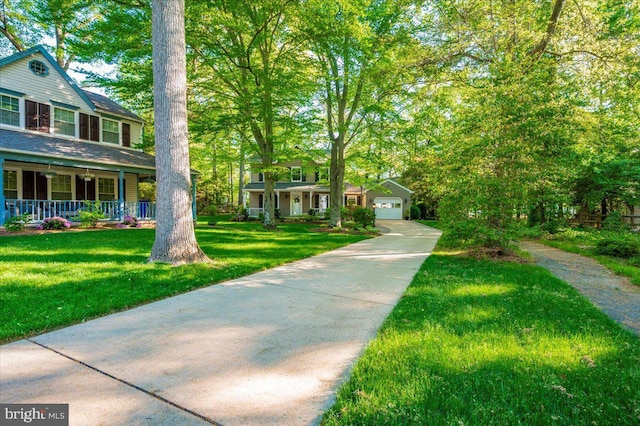 view of front of house with covered porch, a front yard, and a garage