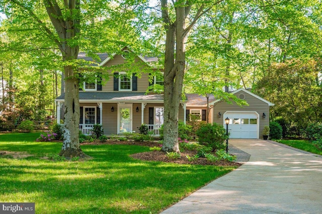 view of front of property featuring a porch, driveway, a front yard, and a garage