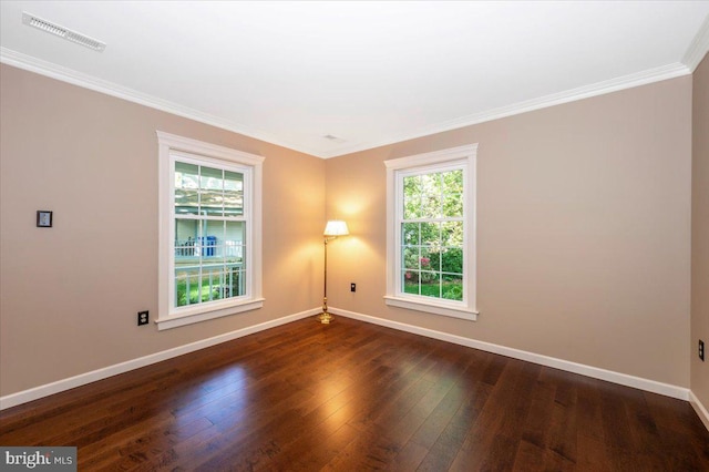 spare room featuring baseboards, visible vents, a wealth of natural light, and hardwood / wood-style floors