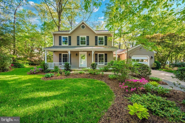 colonial home featuring a porch, concrete driveway, and a front lawn