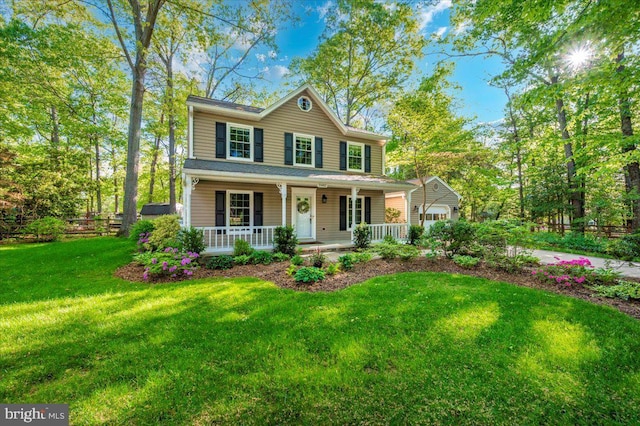 view of front of property with covered porch and a front yard
