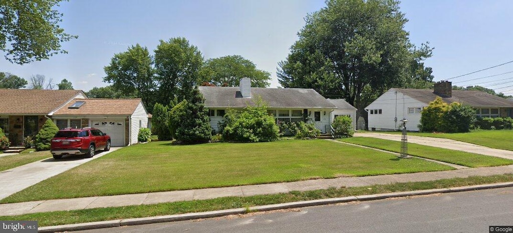 126 Villanova Dr, Trenton, NJ 08648 - view of front of home featuring a garage, a chimney, driveway, and a front lawn