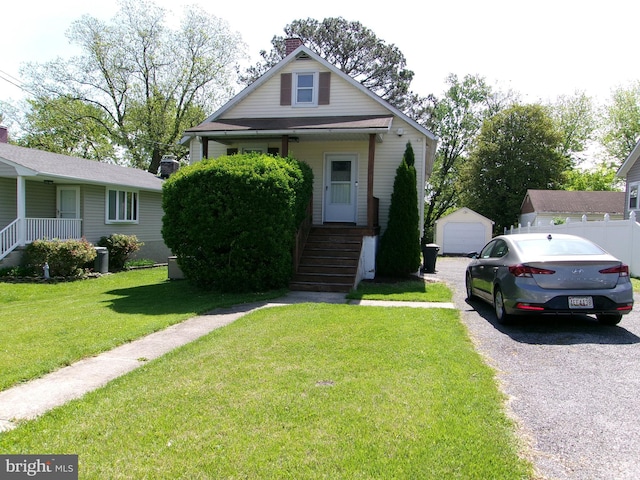 8807 Fearne Ave, Baltimore, MD 21234 - bungalow-style house featuring a detached garage, a chimney, an outdoor structure, and a front lawn