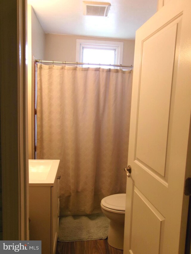 8807 Fearne Ave, Baltimore, MD 21234 - bathroom with visible vents, curtained shower, wood finished floors, vanity, and toilet
