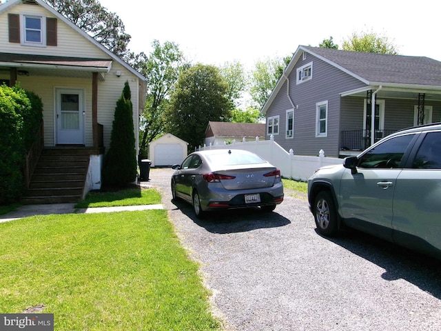 8807 Fearne Ave, Baltimore, MD 21234 - view of side of home with a lawn, fence, and an outbuilding