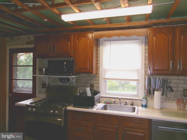 8807 Fearne Ave, Baltimore, MD 21234 - kitchen with black microwave, dishwasher, light countertops, a sink, and range with gas stovetop