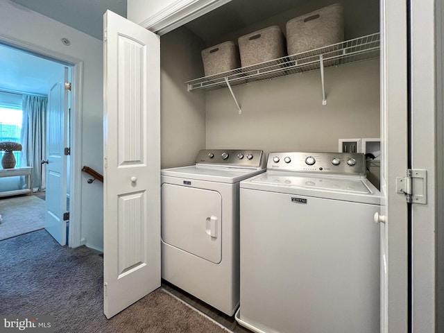 laundry area featuring washer and dryer, laundry area, and dark colored carpet
