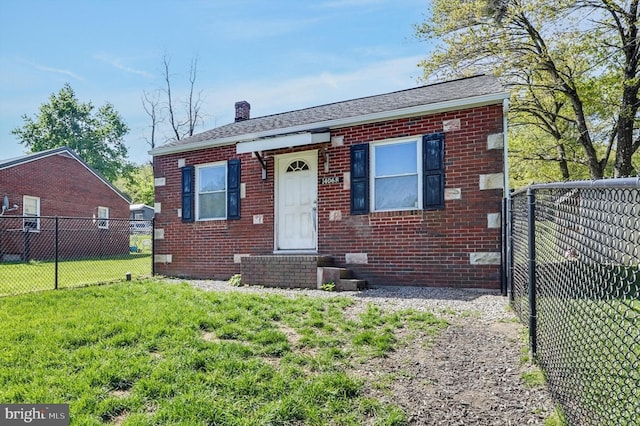 bungalow with brick siding, fence, a front yard, and a chimney