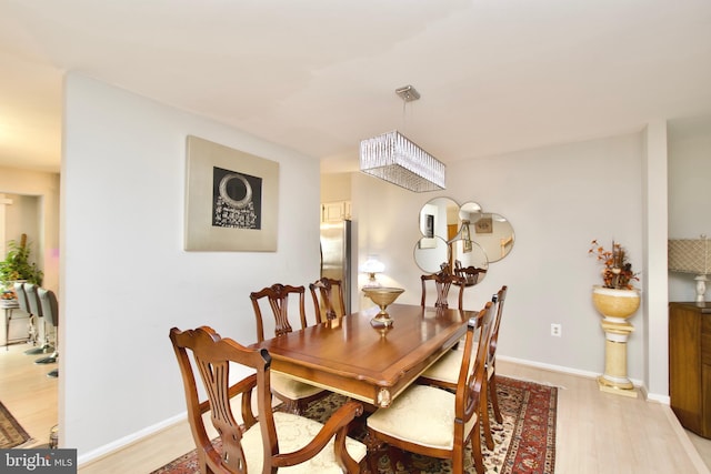 4024 Nicholas Ct, Fairfax, VA 22033 - dining space with light wood-style floors, baseboards, and a chandelier