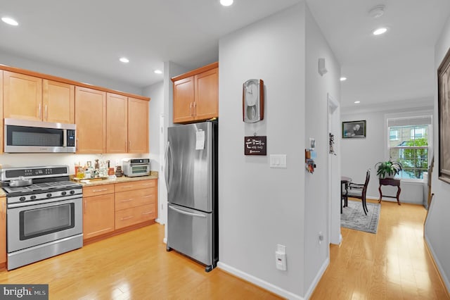 20920 Houseman Ter, Ashburn, VA 20148 - kitchen with light wood-style floors, appliances with stainless steel finishes, and light brown cabinets