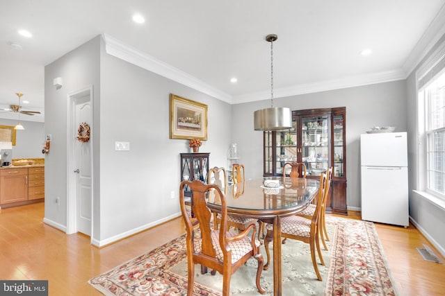20920 Houseman Ter, Ashburn, VA 20148 - dining space featuring visible vents, light wood finished floors, crown molding, and a healthy amount of sunlight