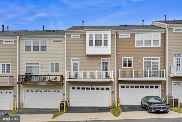 20920 Houseman Ter, Ashburn, VA 20148 - back of house featuring central air condition unit, an attached garage, and driveway