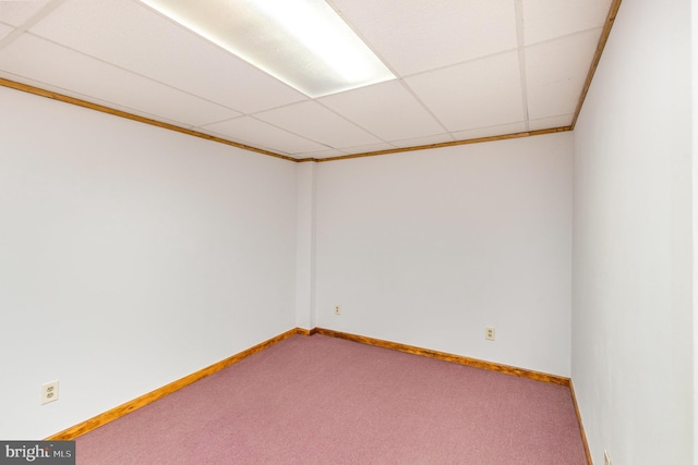 carpeted empty room with baseboards and a paneled ceiling