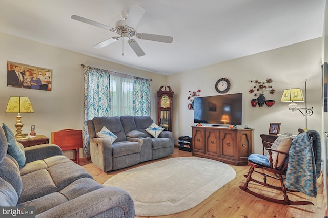 living area with light wood-style floors and ceiling fan