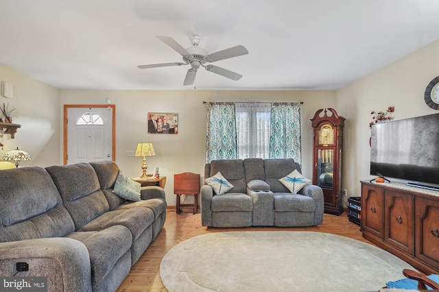 living room with ceiling fan and light wood finished floors