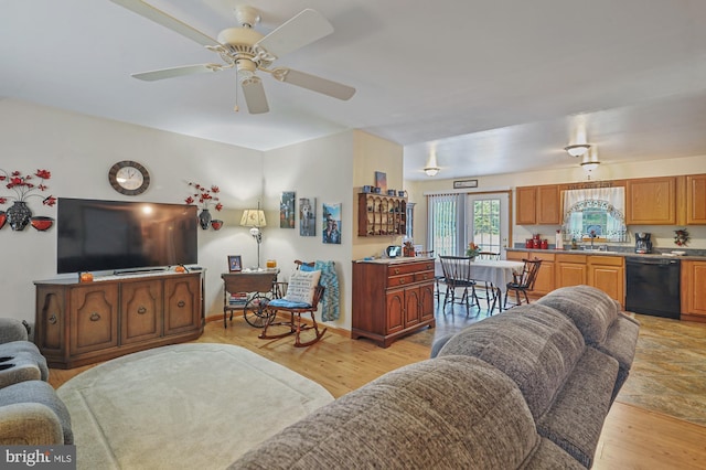 living room with a ceiling fan and light wood-style flooring