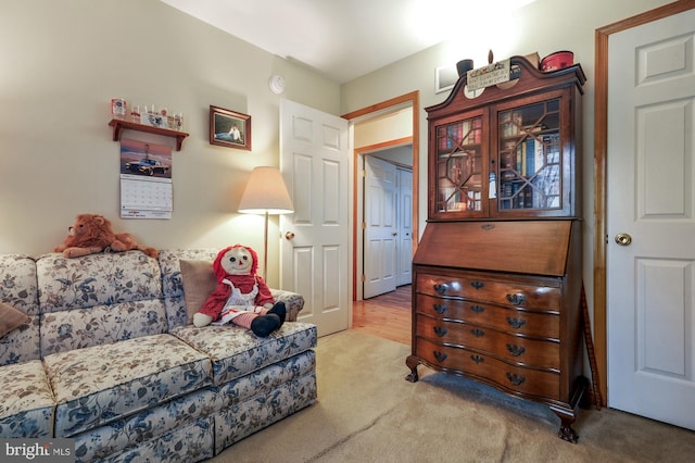 living area featuring visible vents and carpet
