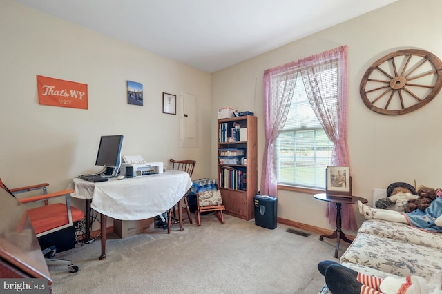 carpeted home office with baseboards, visible vents, and electric panel
