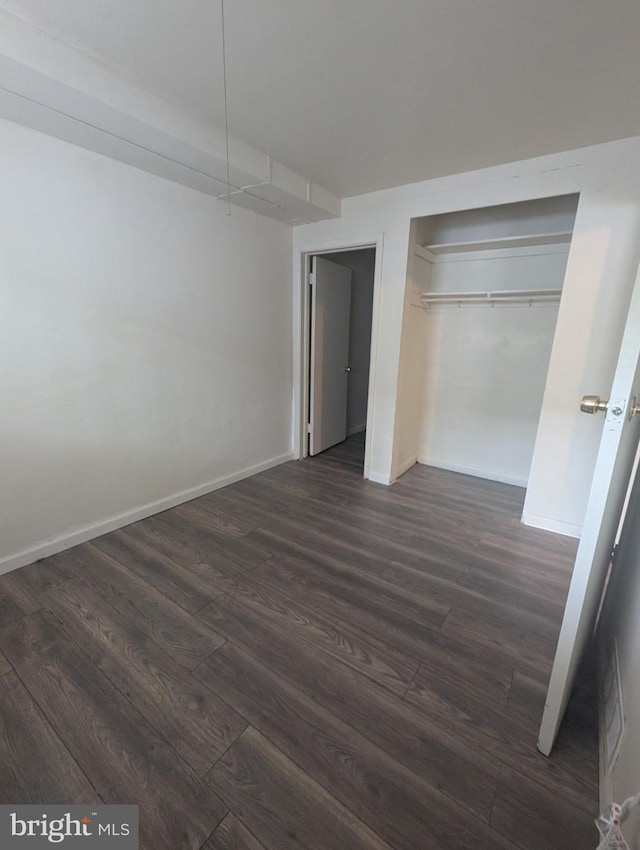 2407 S 12th St, Camden, NJ 08104 - unfurnished bedroom with baseboards, dark wood finished floors, and a closet