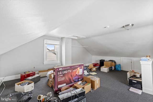 additional living space featuring carpet flooring and lofted ceiling