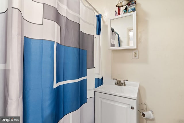 bathroom featuring vanity and a shower with shower curtain