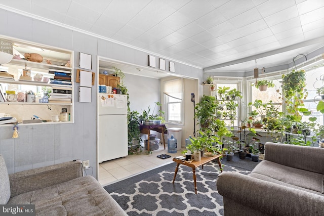 living area featuring crown molding and tile patterned flooring