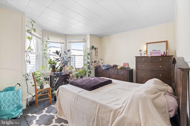 bedroom with carpet floors, multiple windows, and ornamental molding