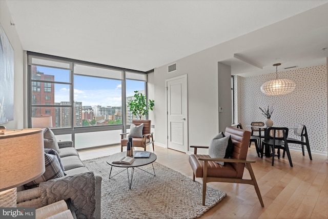 475 K St NW Unit 817, Washington, DC 20001 - living room featuring visible vents, light wood-style flooring, floor to ceiling windows, and baseboards