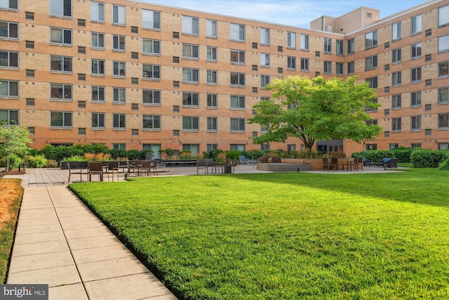 view of home's community with a lawn
